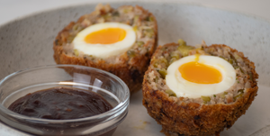 large scotch eggs on a plate with Scotch Bonnet Chilli Jam in the foreground