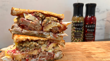 A photo of the christmas toastie, stacked on top of each other and Brussels Sprout Ketchup and Spiced Cranberry Ketchup in the background