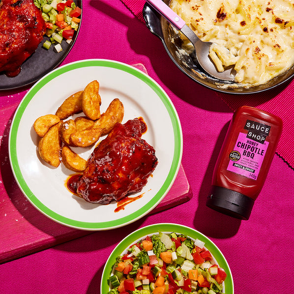 Sauce Shop Honey Chipotle BBQ Sauce on Chicken Thighs Served with Potato Wedges